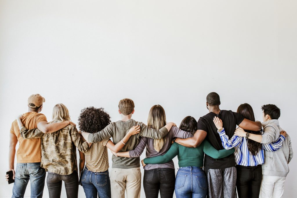 Rearview of diverse people hugging each other