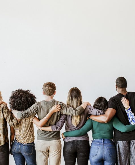 Rearview of diverse people hugging each other